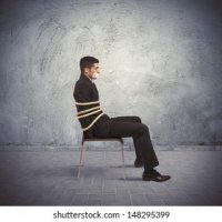 businessman-trapped-chair-rope-260nw-148295399.jpg